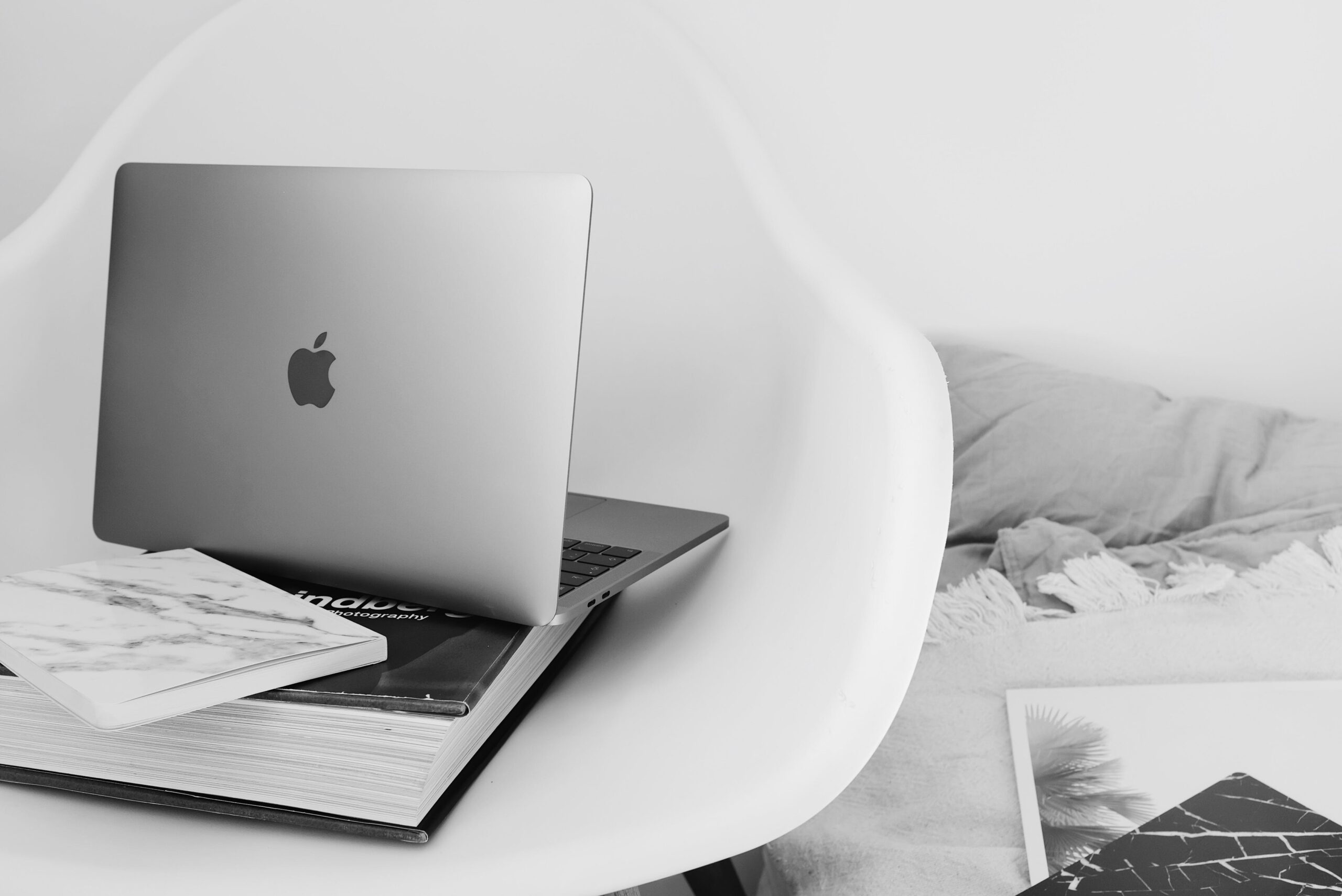Black & white photo of open laptop of a mompreneur that works from home