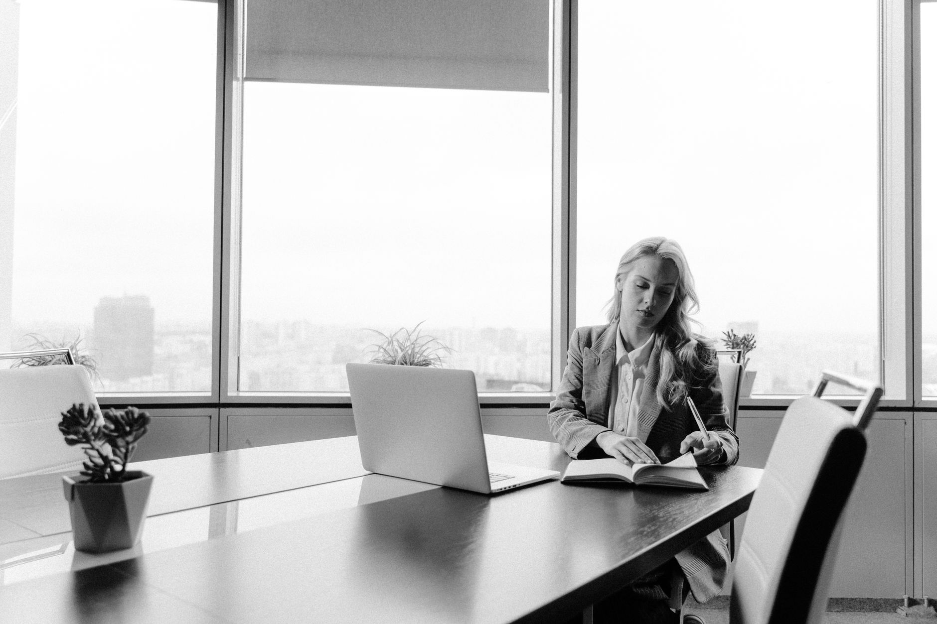 grayscale photo of woman in front of laptop computer